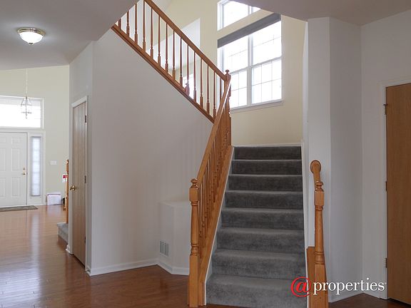 Dual Sided Staircase Open to Family Room and Dinin