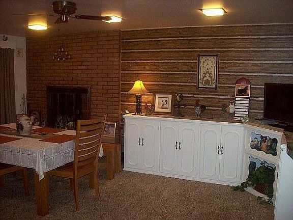 Dining room has fireplace and lots of built in cabinets