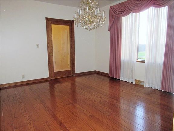 The 14x12 ft. formal dining room boasts gleaming hardwood floors, a glass pocket door leading into the formal living room, and y