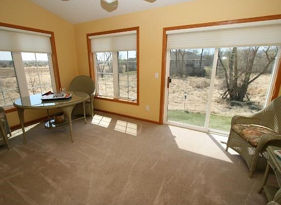 Cozy sunroom space overlooking an abundance of nature.