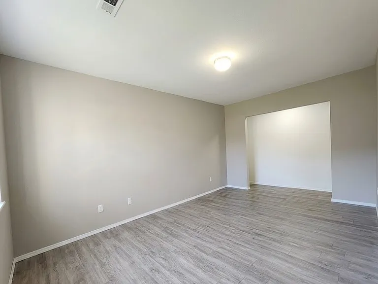 Oversized downstairs bedroom with potential for second primary suite or flexible living space.