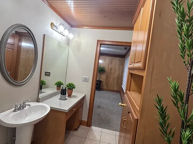 large bathroom with built-in cabinets and storage space