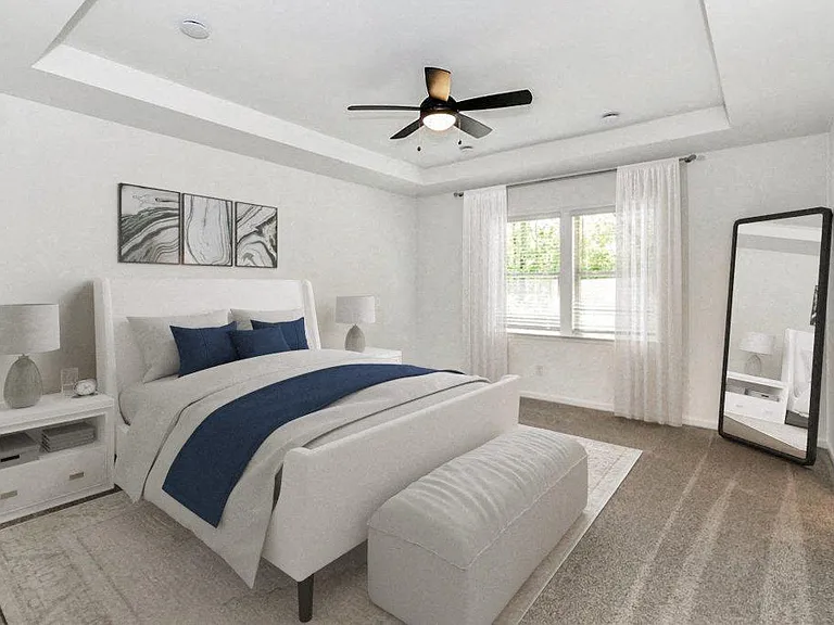 Third bedroom with a queen-size bed and abundant natural light streaming through the window.