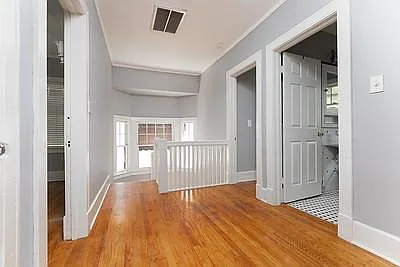 Upstairs hallway with ceiling fan, refinished Oak floors. Linen closet.