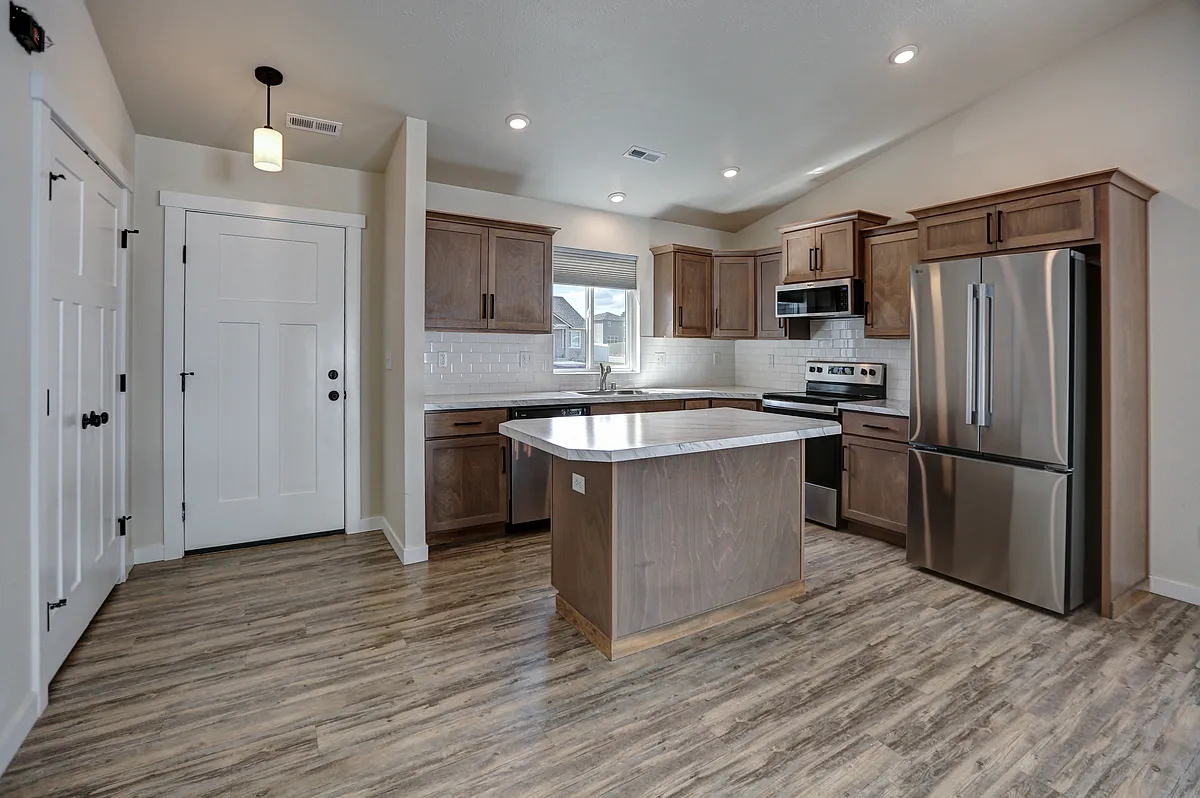 Kitchen - Stainless Whirlpool Appliances. Electric Glass Top Range, Slim Microhood, Dishwasher & Side X Side Fridge, Double Door Closet Can Be Used As Closet Or Pantry, Front Door - 10404 W Lingonberry Ct