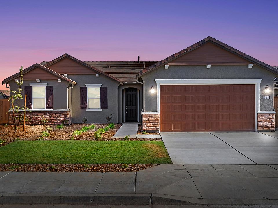Home Front View with beautiful land scaping and two car drive away