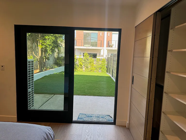Guest bedroom #2 has a sliding door to landscaped and fully enclosed back yard.