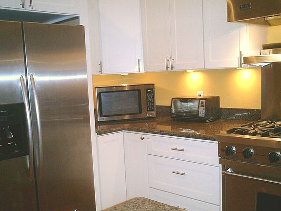 Kitchen features a Viking range with hood and warmer