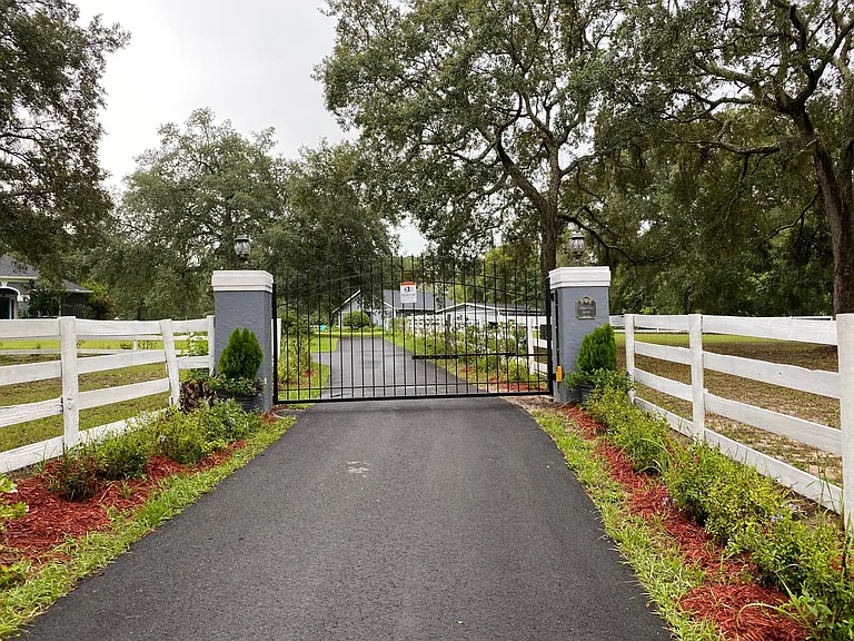 New Wrought Iron gate and motor. The pillars were just painted to match the house