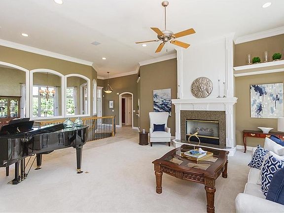 This great room is so very pretty - natural light, a view to the pond and spacious enough to hold all of your furnishings.