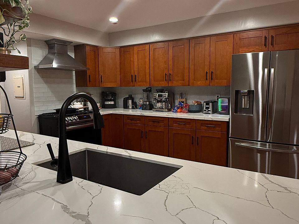 Elegant Kitchen with Calacatta White Quartz Counters and Cherry Oak Shaker Cabinets.