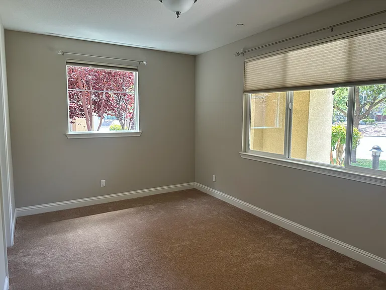 Secluded 1st-floor guest suite_perfect for visitors, an in-law room featuring multiple windows, walk-in closet and attached full bath