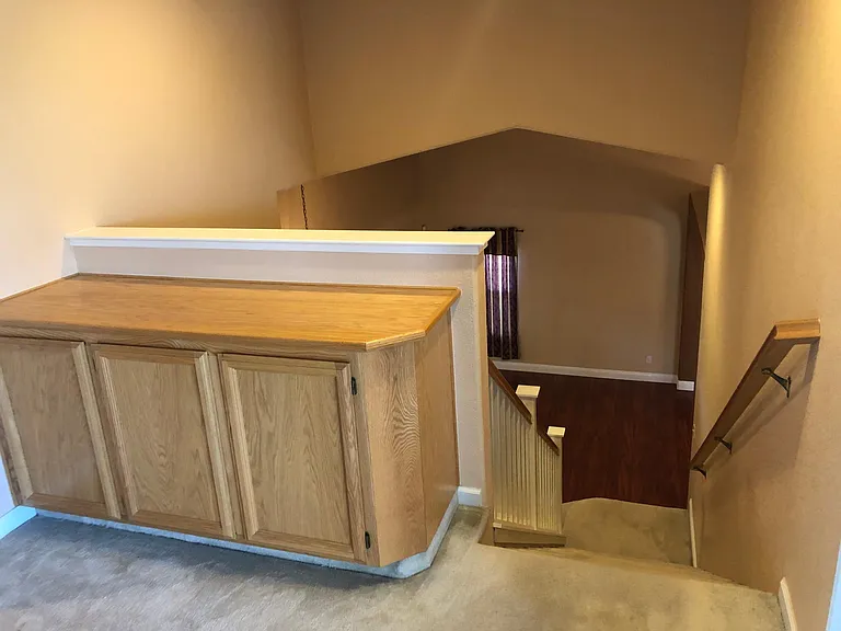 Linen closet, stairways to the living room downstairs