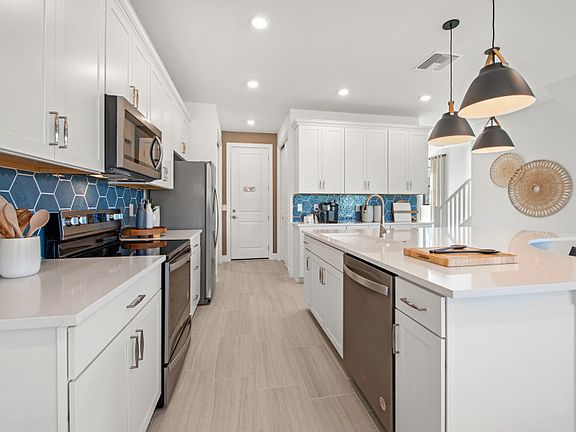 Kitchen with large center island, granite countertops, Moen R faucet, and customizable designer fin