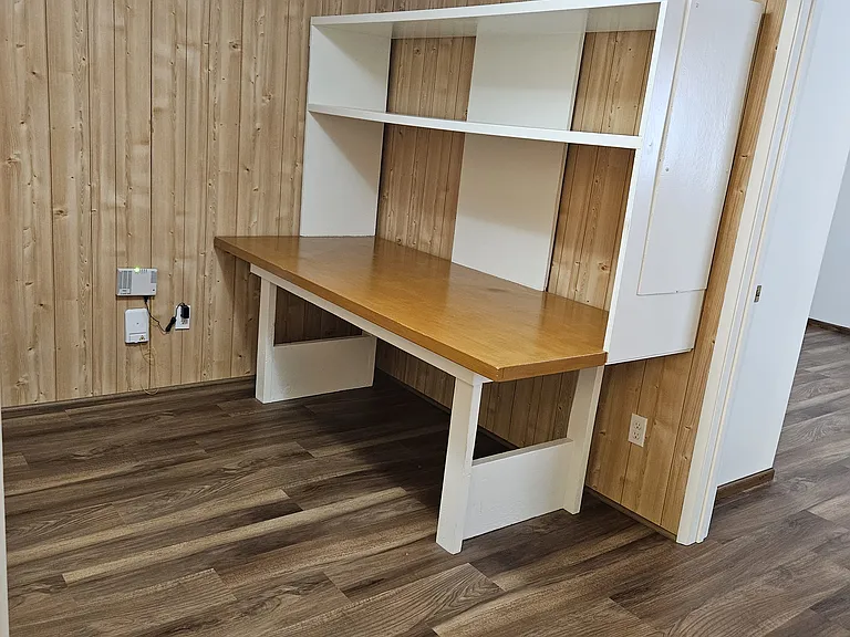 Upstairs room between E bedroom and bathroom, furnished with desk.