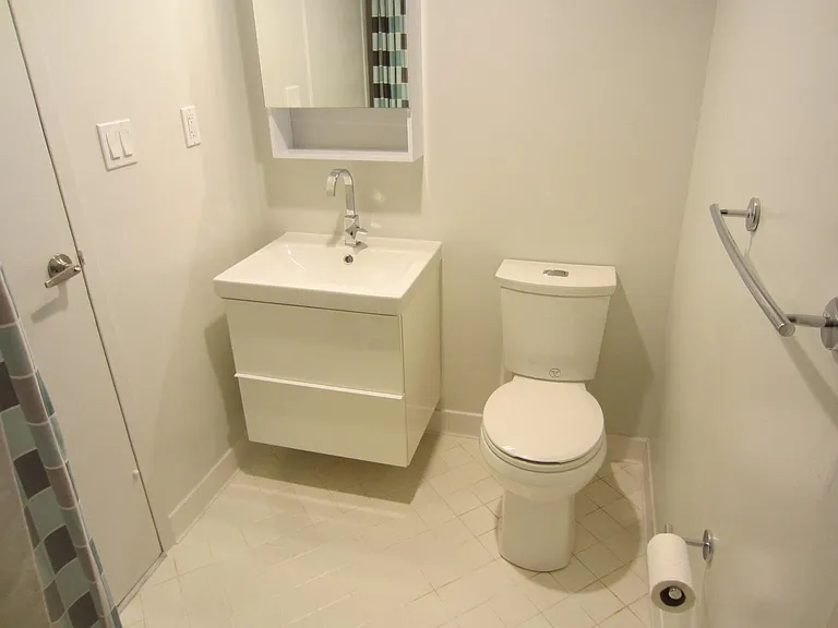 RENOVATED BATHROOM WITH MODERN FURNITURE AND ACCESSORIES