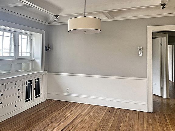Dining room with built in buffet and coffered ceilings.