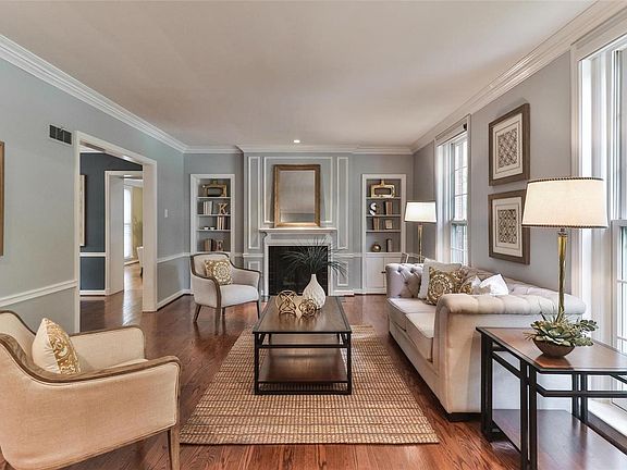 Living room features a vented gas fireplace and built-in bookshelves.