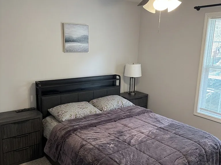Well-appointed guest bedroom with cozy furnishings and a bright, inviting feel.