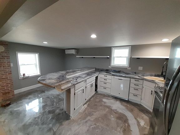 Open kitchen with bar and dining area, dishwasher, garbage disposal, self-cleaning oven, side by side refrigerator with ice-maker. Lots of storage.