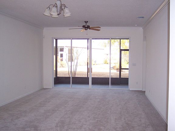 Great Room w/crown molding and sliders to screened lanai