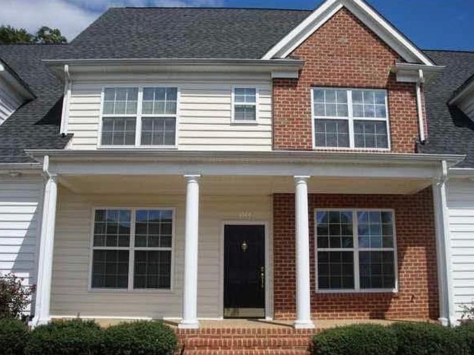 Covered front porch with entry to dining room, stairs, and downstairs room for office, music, playroom. Reserved parking spaces with ample parking for visitors.