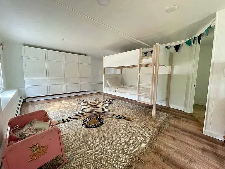 Downstairs bedroom (bed can be converted to king). The bathroom is through door on the right.