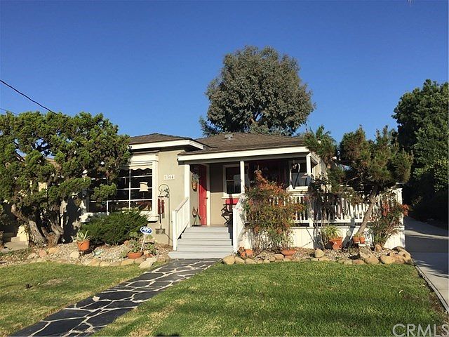 House and wrap around front porch as seen from the street
