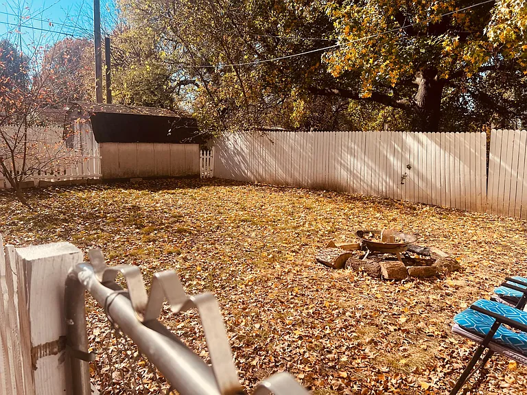 Fully fenced backyard with firepit. Storage shed in back.