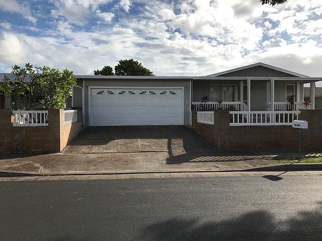 Enclosed two car garage, and gated front yard.