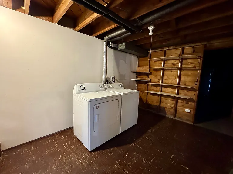 Laundry area and interior door to private garage