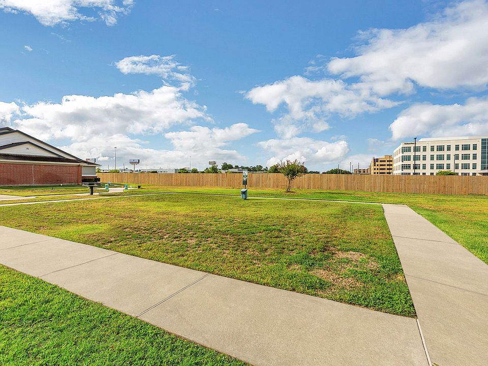Outdoor grilling area with BBQ grills and seating at Humble Memorial Gardens in Humble, TX.