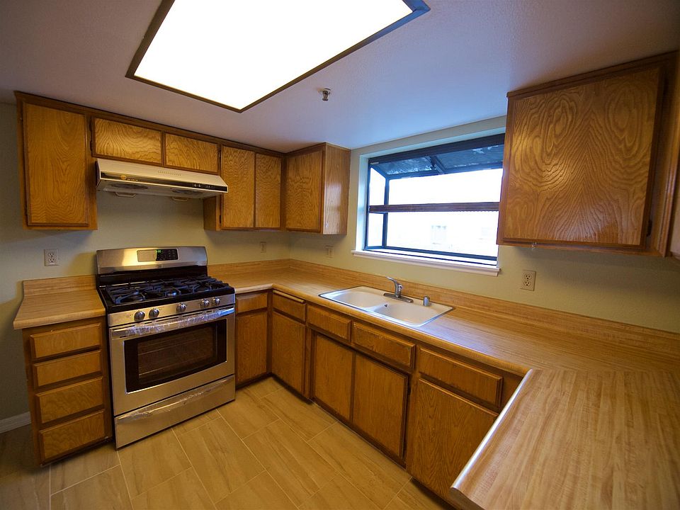 Kitchen with new tile floor and stainless steel range