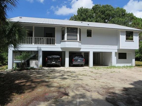 Ample parking in the carport. Note: Property has been landsc