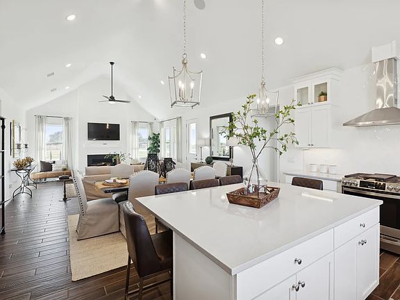 Kitchen with vaulted ceiling and pendant lighting