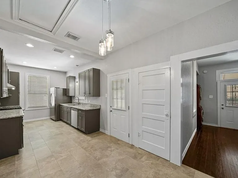 Dining area looking into Kitchen, Laundry room, 2 back doors, basement entry