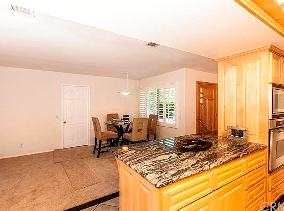 One side of kitchen is open to dining area.  Direct access to garage/laundry