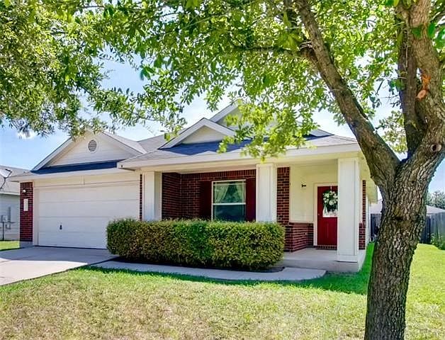 Adorable red brick home with white trim located on a quiet cul-de-sac street in the charming suburb of Hutto!