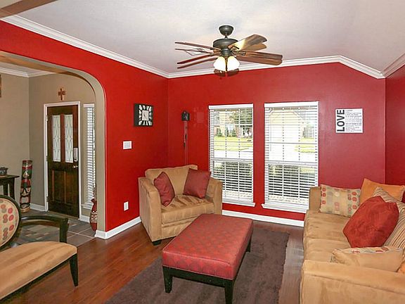 Enter into this bright formal living room with the crown molding.
