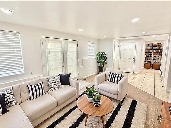 Bright and inviting living room with stylish decor, cozy seating, and a modern design, perfect for relaxation and entertainment.