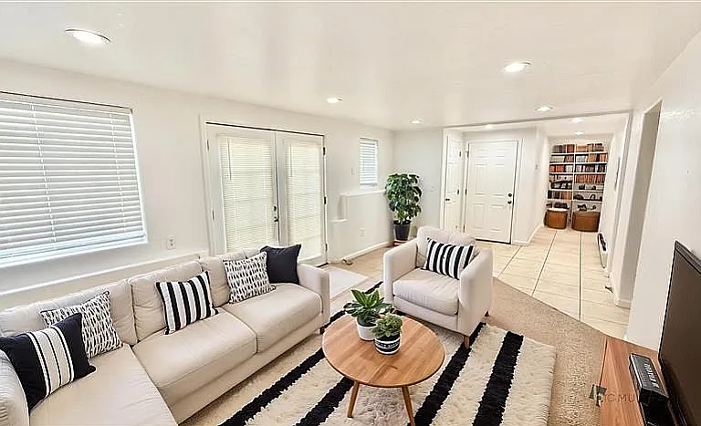Bright and inviting living room with stylish decor, cozy seating, and a modern design, perfect for relaxation and entertainment.
