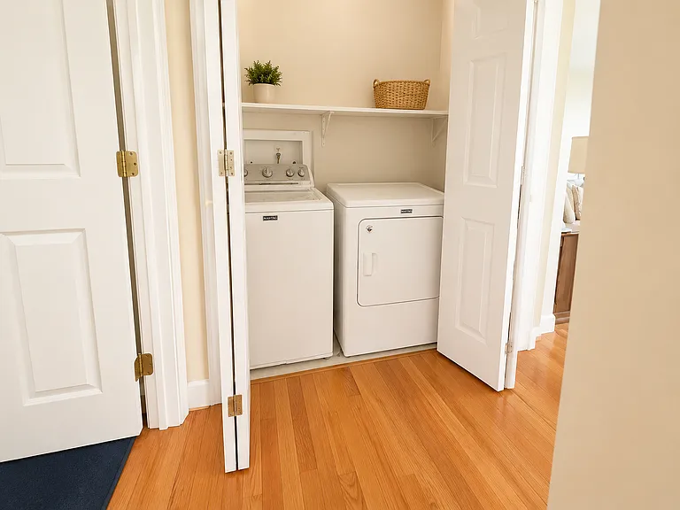 Upper level washer and dryer between bedrooms