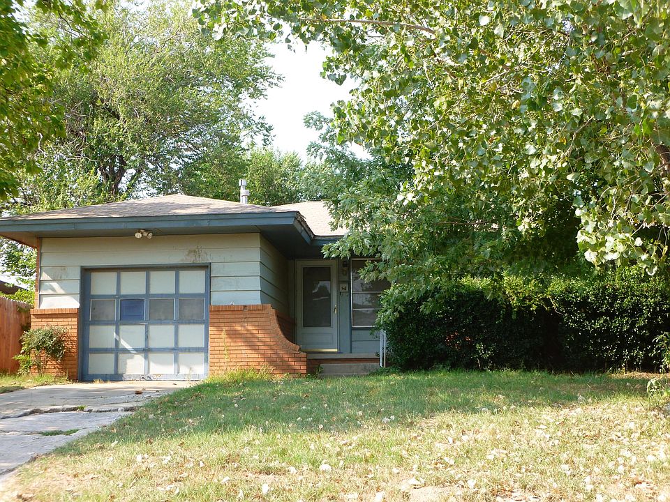 Front - before new driveway and before painted garage door