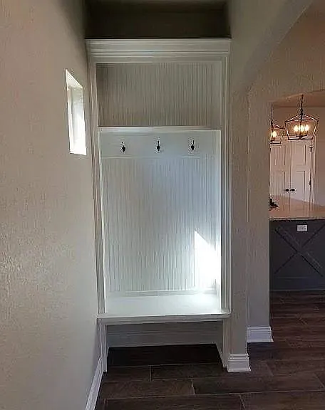 coat rack and boot area just inside back door off kitchen