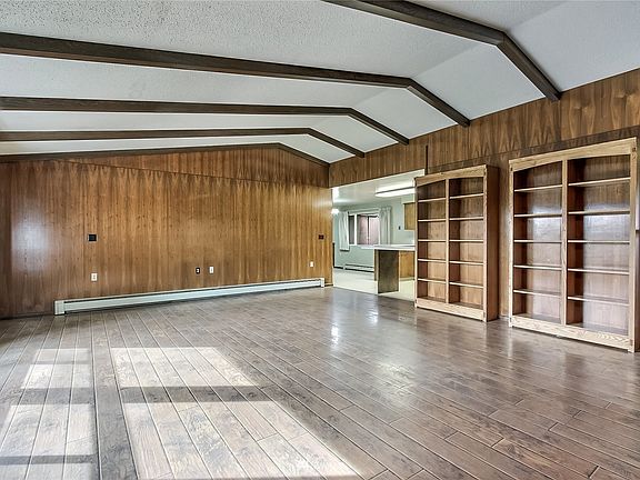 View two of family room, note all the light and built-in bookcases! Kitchen is ahead and entry is to your right. 