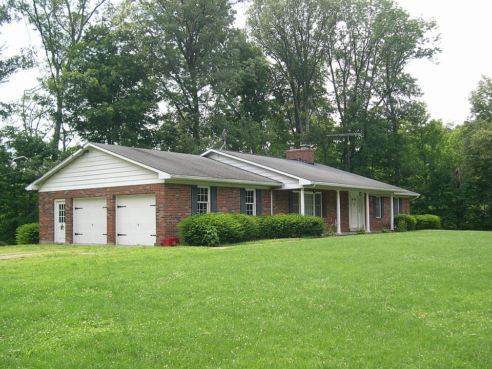 Front of house with 3 acres of lawn. Two car garage.