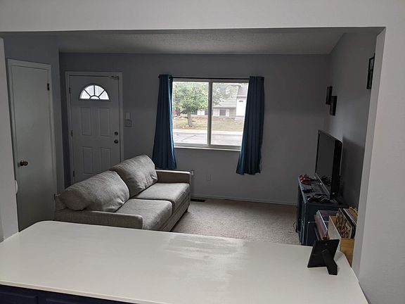 Living room and entry way with coat closet