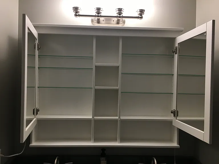 Storage cabinet above sinks in primary bathroom