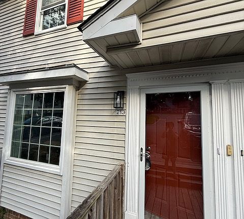 Front door. New storm door, new paint. Beautiful neighborhood, old trees, lots of grass.