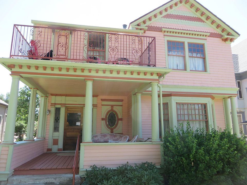 Front of house. The upstairs balcony and upstairs window are part of this available apartment
